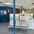 Bright and inviting laundromat with modern seating, vibrant blue walls, and efficient washing machines at Canfield Apartments in Gansevoort, NY.