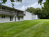 Charming apartment complex with spacious balconies overlooking lush, green lawns and surrounded by serene trees at Halfmoon Garden Apartments in Clifton Park, NY.