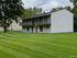 Charming two-story building with spacious balconies set amidst lush green lawns, perfect for creating serene outdoor moments at Halfmoon Garden Apartments in Clifton Park, NY.