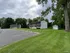 Charming apartment buildings with ample parking set amidst lush green lawns and mature trees at Halfmoon Garden Apartments in Clifton Park, NY.