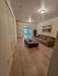 Cozy living room featuring a comfortable sofa, elegant wooden coffee table, and large sliding glass doors leading to a serene backyard.