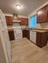 Inviting kitchen featuring modern wood cabinets, sleek appliances, and a large window.