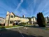 Charming suburban apartment complex with two-story beige buildings and surrounding greenery.