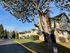 Inviting suburban apartment complex surrounded by mature trees and lush landscaping.