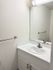 Modern bathroom vanity with a sleek white marble countertop and polished silver fixtures.
