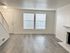 Spacious living room with large windows, elegant flooring, and a contemporary fireplace.