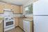 Inviting kitchen with modern appliances, beige cabinetry, and a bright window view.