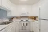 Bright, elegant kitchen featuring pristine white cabinets, modern appliances, and ample counter space for gourmet cooking.