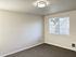 Bright and inviting room with soft natural light, neutral walls, and a modern ceiling light.