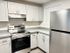Modern kitchen with sleek stainless steel appliances, white cabinets, and ample countertop space for culinary adventures.