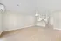 Modern open-concept apartment with sleek flooring, bright kitchen, and welcoming layout, perfect for stylish living.