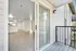 Bright and airy apartment with elegant flooring, an inviting balcony view, and modern kitchen space.