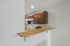 Sleek modern kitchen with elegant wooden cabinets and a stylish breakfast bar, perfect for casual dining and entertaining.