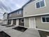 Modern townhouse exterior with charming architectural design, featuring clean lines and welcoming entryways, perfect for contemporary living.