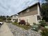 Charming, modern townhouse exterior with lush landscaping and inviting curb appeal.