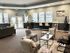 Inviting community lounge with stylish seating, natural light from large windows, and modern decor for relaxation or work.
