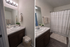 Elegant bathroom featuring a marble countertop, modern lighting, and a cozy shower area with soft towels and chic decor.