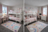 Charming children's bedroom with bunk beds, pastel rainbow decor, and a cozy study nook.