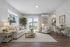 Bright and elegant living room featuring plush seating, stylish decor, and natural light streaming through large windows with a view.