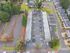 Aerial view showcasing a vibrant apartment complex with ample parking surrounded by lush greenery - a perfect blend of convenience and nature.