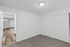 Bright and inviting room with fresh carpeting, sleek hardwood floors, and soft lighting, ideal for modern living.