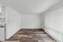 Bright and airy apartment space featuring elegant wood flooring and modern vertical blinds, offering a fresh and inviting atmosphere.