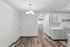 Modern apartment interior featuring a chic dining area with elegant lighting, seamless blend of wood flooring, and a stylish open kitchen layout.