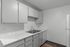 Elegant and modern kitchen with sleek white cabinetry, marble countertops, and stainless steel sink, ideal for culinary creativity.