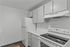 Modern kitchen with sleek white cabinets, elegant marble countertops, and state-of-the-art appliances.