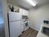 Contemporary kitchen with white cabinetry, modern appliances, and chic decor, perfect for culinary creativity.