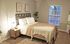 Centennial Ridge bedroom with warm decor, elegant bedframe, and soft lighting.