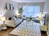 Bright and stylish Centennial Ridge living room with modern furniture, cozy rug, and large window bringing natural light.