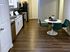Centennial Ridge kitchen with sleek cabinets, modern appliances, and a stylish dining set.