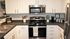 Stylish Centennial Village kitchen with modern appliances, sleek countertops, and elegant cabinetry.