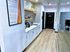 Sleek Centennial Village clubhouse kitchenette in a modern hallway with stylish backsplash, open shelving, and bright flooring.