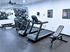 Centennial Village apartment gym equipped with treadmills, exercise bike, and weights for an enhanced workout experience.