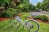 Inviting Chase Courtyard entrance with vibrant greenery and a modern bicycle, showcasing the essence of Eugene living.