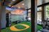Fitness area with vibrant sports mural and exercise equipment at The Flats at Chase in Eugene, OR