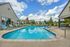 Resort-style outdoor swimming pool in the Gardens area at Chase Village apartments in Eugene OR