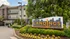 Charming apartment building with lush landscaping at The Landings Riverside Living, offering serene and stylish community living.