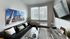 Modern living room with black sofa and mounted TV at The Flats at Chase student apartments in Eugene, OR