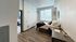 Bright cozy bedroom with wooden flooring and natural light at The Flats at Chase in Eugene, OR