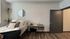 Modern bedroom with cozy bed, work desk, and hanging plant at The Flats at Chase in Eugene, OR
