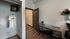 Bedroom with wooden floor, work desk, and open closet at The Flats at Chase in Eugene, OR