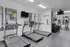 Modern fitness center featuring state-of-the-art treadmills, weight rack, and mirrored walls for an invigorating workout experience.