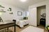 Furnished private bedroom with green accents and workspace at Stadium Park student apartments in Eugene OR