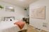 Furnished model bedroom with study nook and world map decor at Stadium Park in Eugene OR