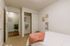 Furnished model bedroom with open closet and stylish wall art at Stadium Park in Eugene OR