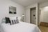 Furnished bedroom with plush bedding and open closet at Stadium Park in Eugene OR