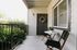 Private patio with wicker furniture at Stadium Park student apartments in Eugene OR